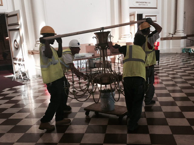 Wooden Nickel Was Salvaging And Preserving Long Before It Became Workers Roll The Brass Of A Chandelier Across Lobby Floor In Hall During Renovations Wooden Nickel Was Tasked With Removing And Storing