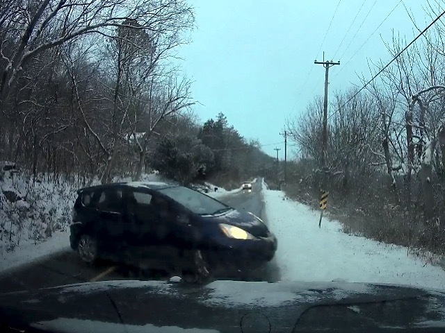 Dash cam catches this auto hitting ice, skidding into police vehicle